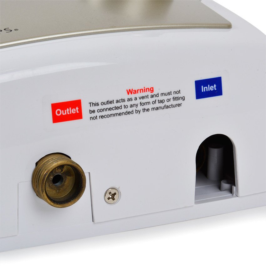 Close-up of a plumbing outlet with labeled 'Outlet' and 'Inlet', featuring warning text.